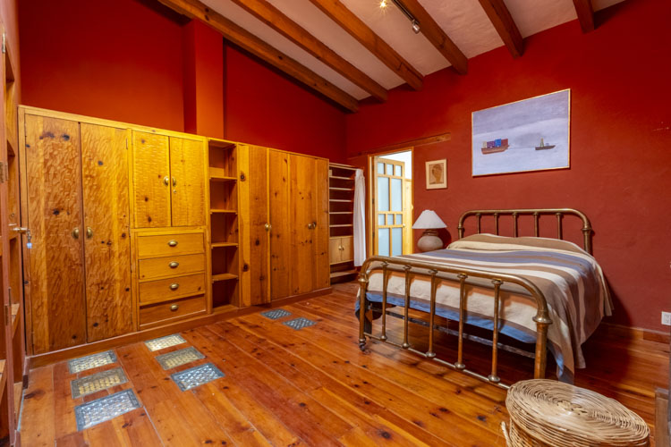 furnished master bedroom with large wooden closet