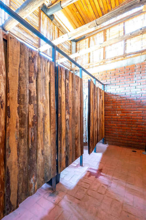 mens and womens restrooms bathrooms in restaurant with rustic wooden dividers