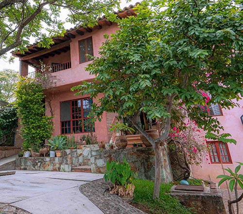 light red exterior of large home house for sale in San Felipe del Agua Oaxaca Mexico