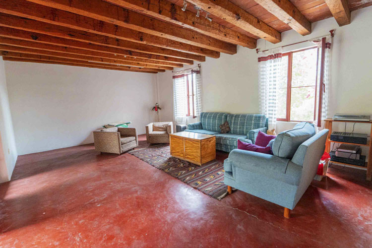 living room with wooden beamed high ceiling