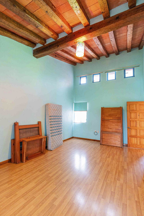 second bedroom with blue walls and natural light from five windows