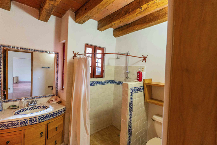 bathroom with white tile and talavera with blue decoration