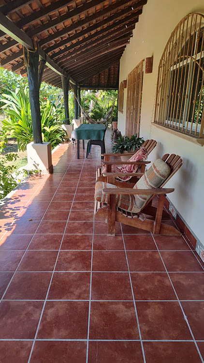 patio with tile floor and wooden overhang roof