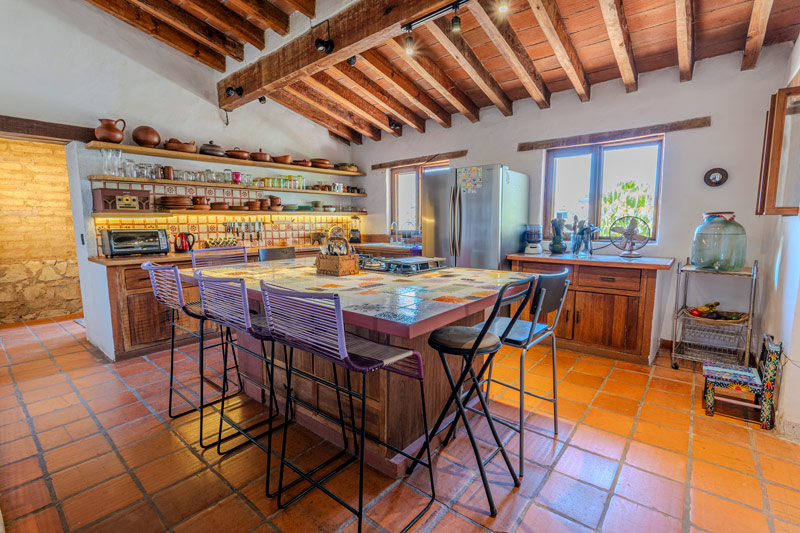 kitchen in adobe house with hand blown glass island countertop