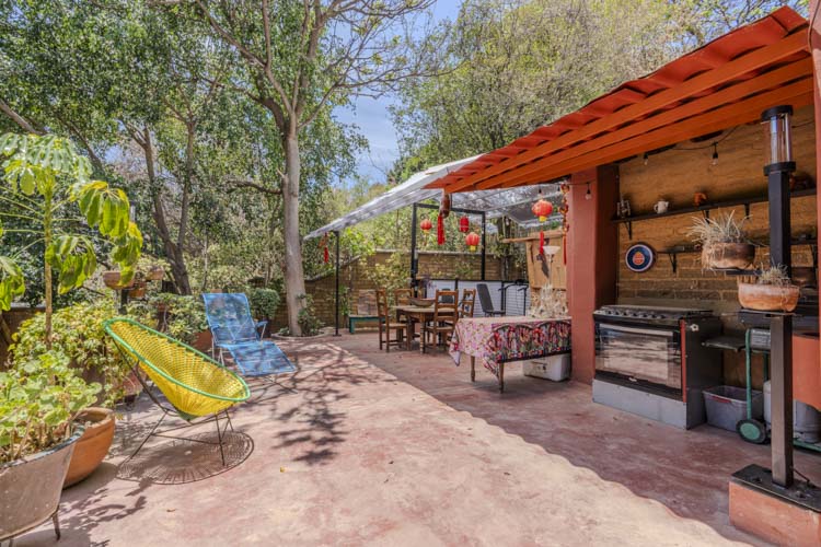 outdoor patio and outdoor kitchen under Spanish tile roof and French drain