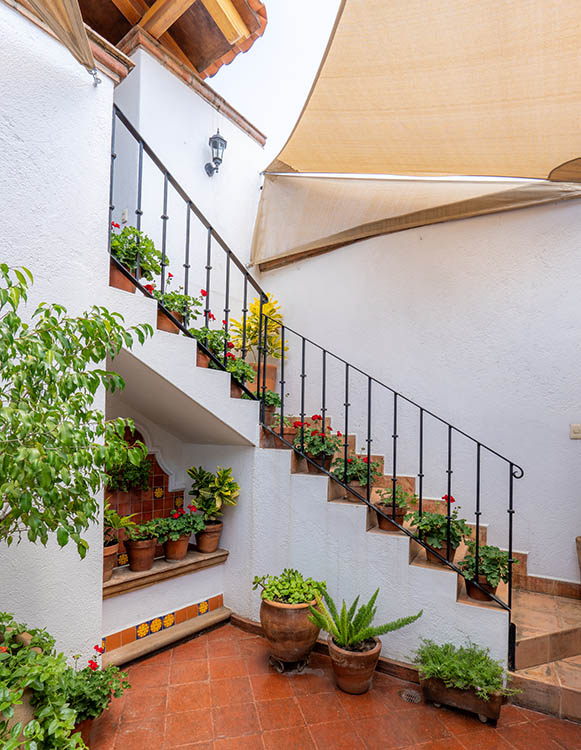 central stairwell on colonial oaxacan patio with fountain to the side