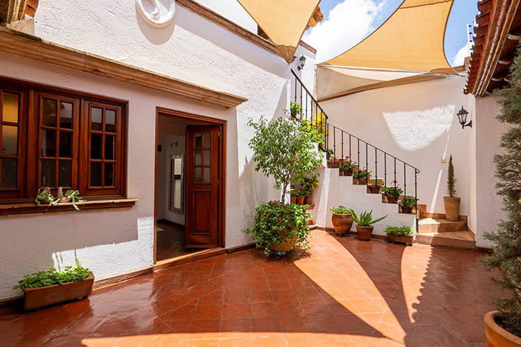 Oaxaca home for sale courtyard with colonial staircase and fountain