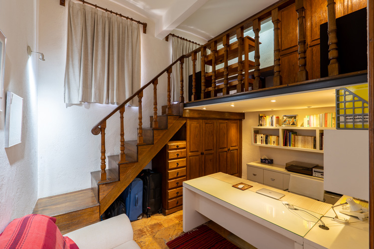 bedroom with wooden loft and white desk