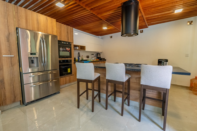 Kitchen area with table and wooden rafters on ceiling