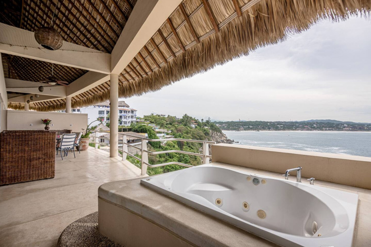 palapa and jacuzzi tub on balcany at at beachfront condo for sale