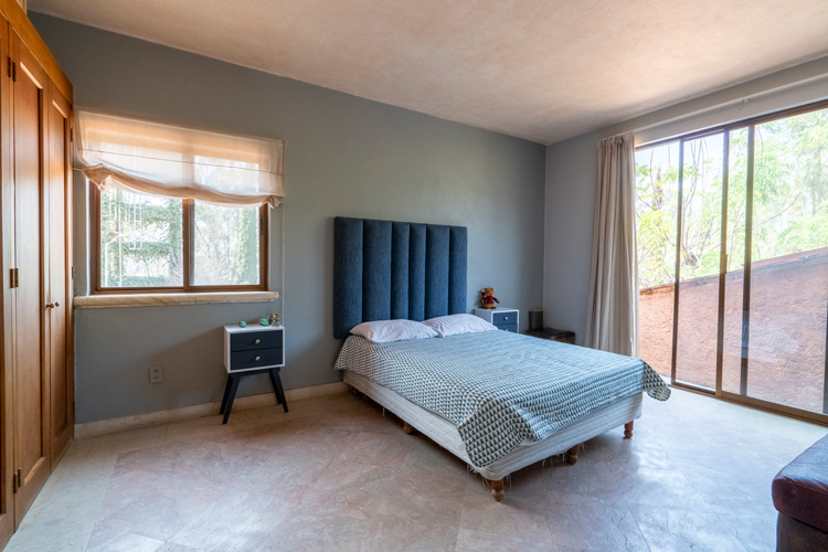 Master bedroom with bed and natural light