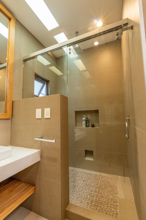 full bath with shower with glass door and tile work