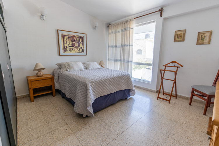 bedroom with natural light on bed