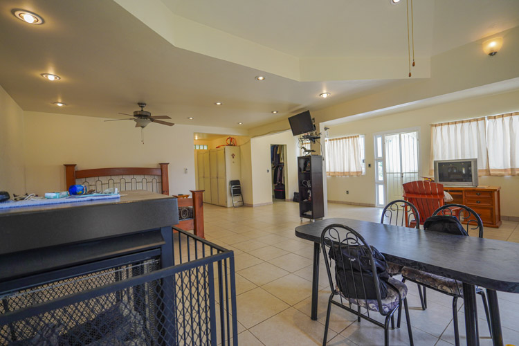 master bedroom suite with gas fireplace and door to rooftop terrace deck