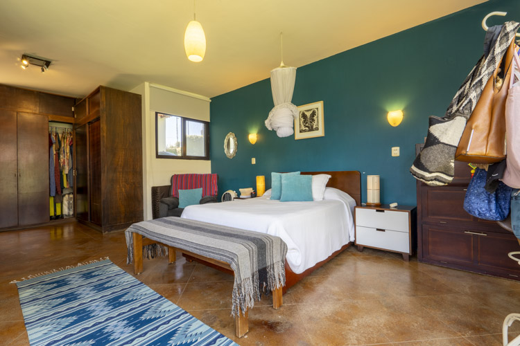 bedroom with blue wall and wooden closet