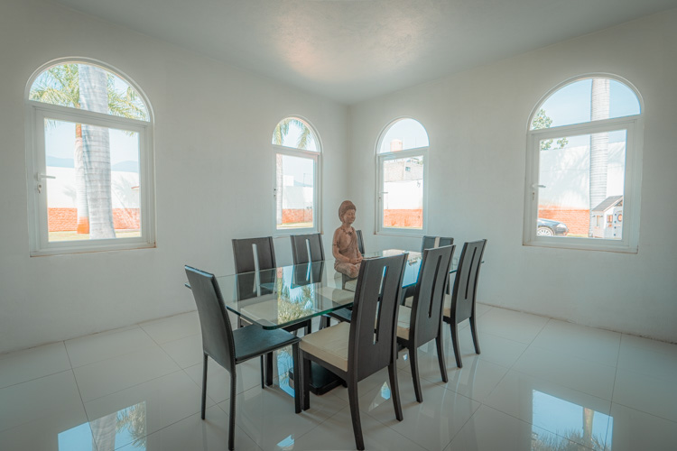 dining room with glass dining table and seating for 8 people