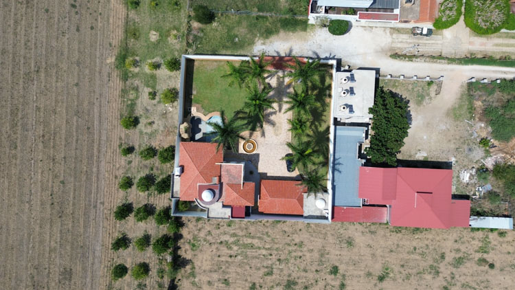 aerial photo of casa en venta home for sale in Tlalixtac de Cabrera Oaxaca with wall and palm trees