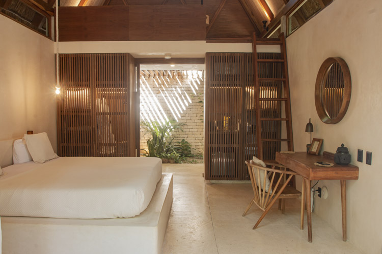 eco chic cabin in Tulum hotel bed and natural wooden desk