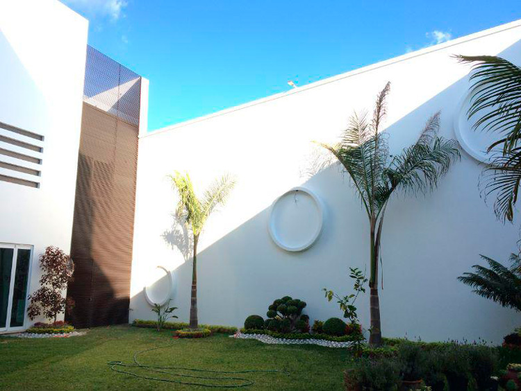 white exterior and grass lawn at house for sale in San Felipe del Agua