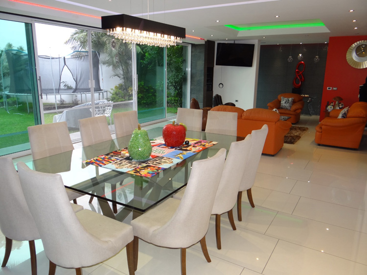 dining room with glass table with seating for 10 and wall height windows with good natural light